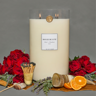 Dark and Handsome Big Ass Candle with red roses, oranges and matches surrounding it.