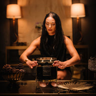 Woman setting candle in candle holder 