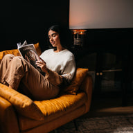 Woman Reading with Big Ass Candle in the Background