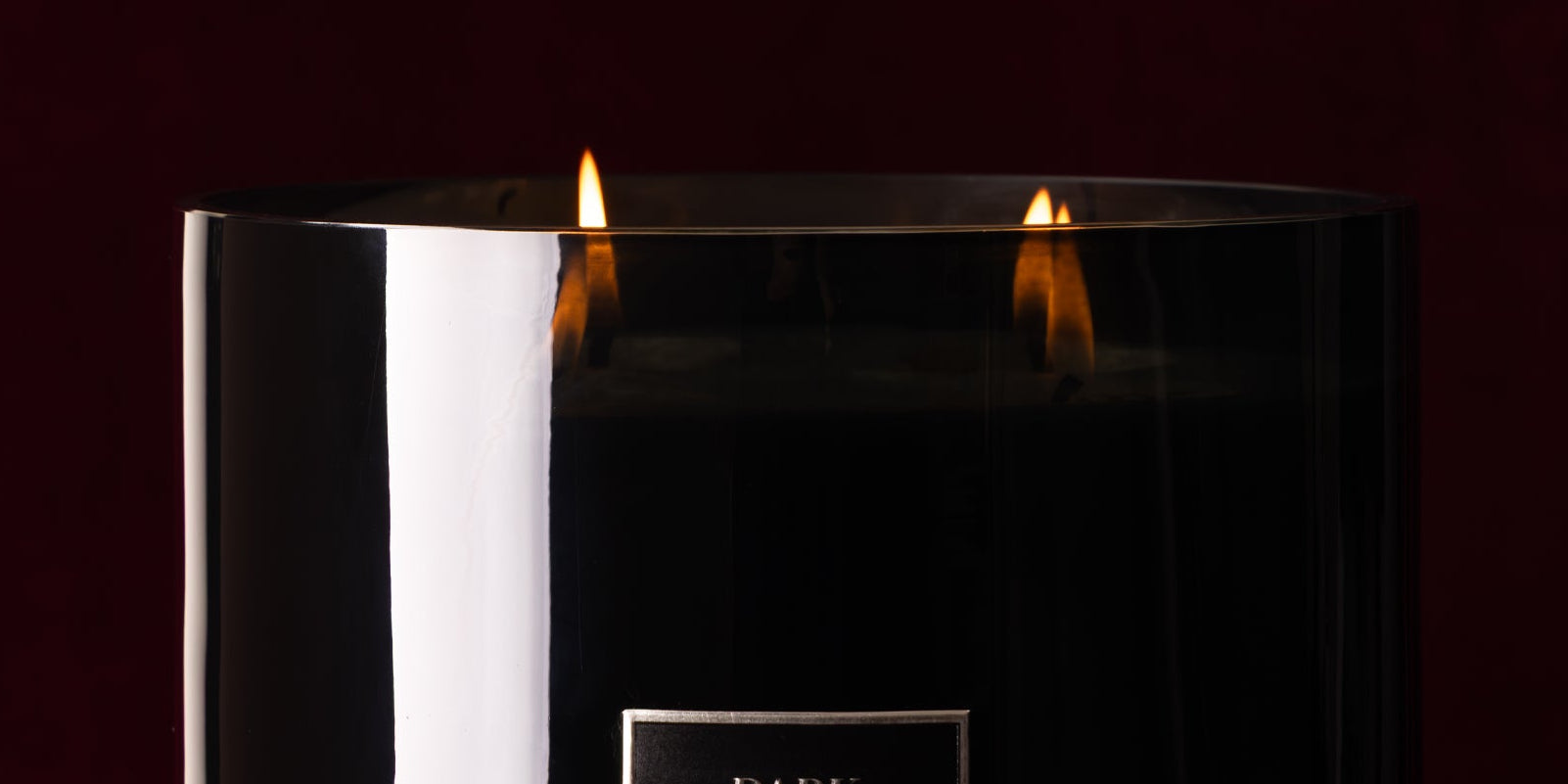 Candle in a glass holder with a dark background