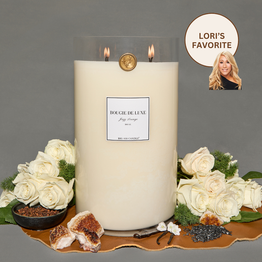 Lit Jazz Lounge Big Ass Candle with white roses surrounding it