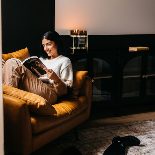 Model reading a book with candle lit